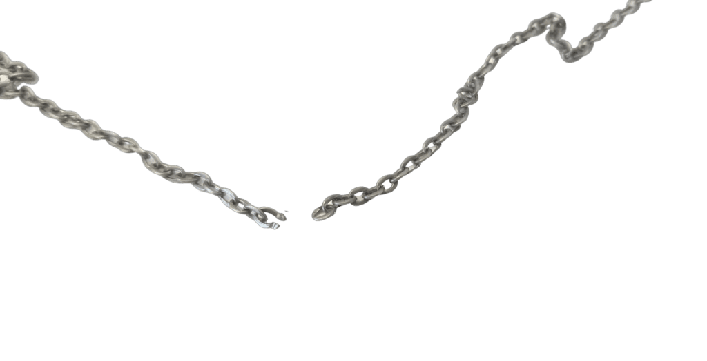 A broken silver chain on a black background, illustrating the need for careful maintenance of jewelry.